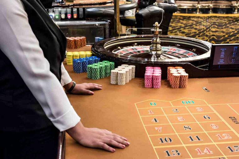 Roulette table with players placing bets on different numbers